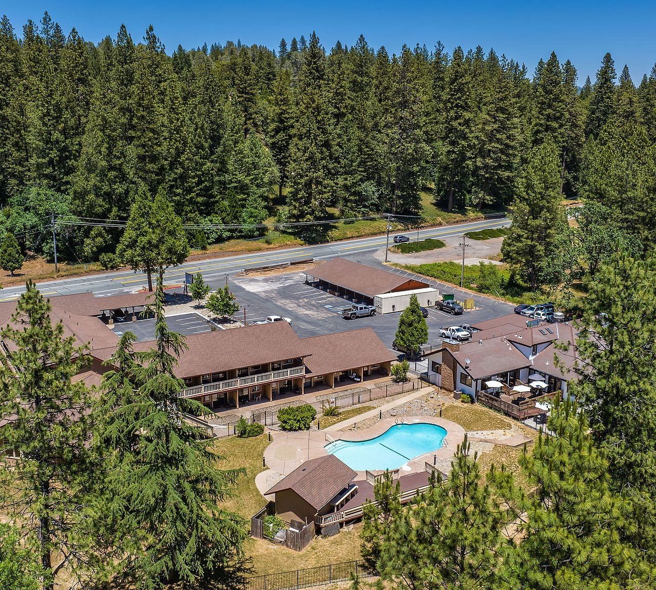 An aerial view of Amador Hotel with a forest in the backdrop