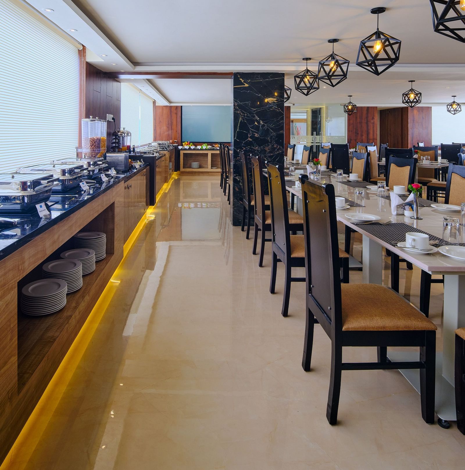 Table arrangement besides the buffet set up at Blue Salt and Coffee at Essentia Premier Hotel, Chennai