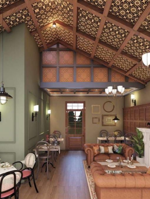 Cosy dining space featuring a high, textured ceiling, sage green accent walls, and a white fireplace at BluSalzz Terrah Hills Resort, Dalhousie.