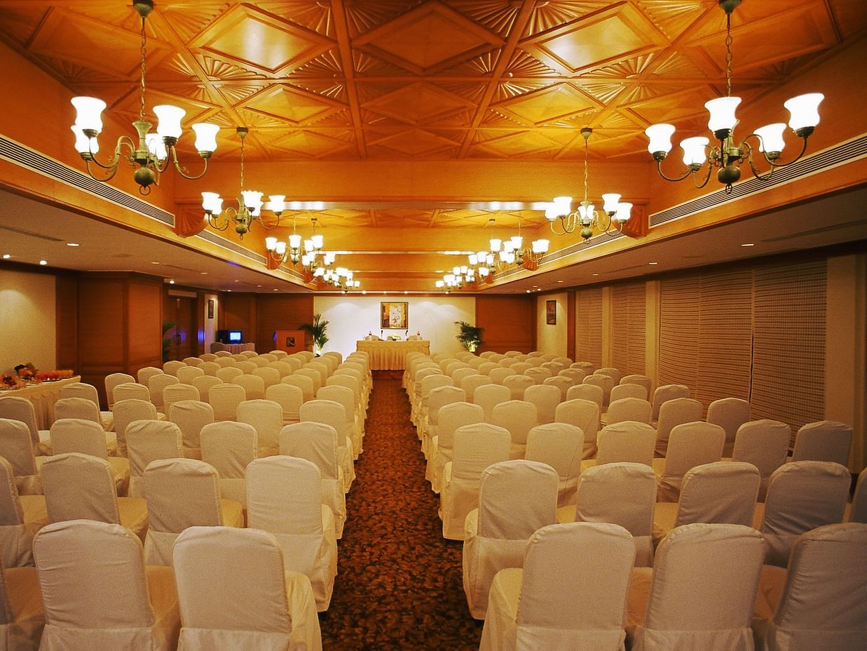 Regency 1 Banquet hall looks immaculate in splendid lighting as rows of white seats are lined up facing the podium 
