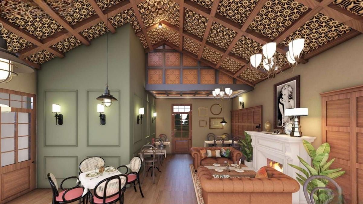 Cosy dining space featuring a high, textured ceiling, sage green accent walls, and a white fireplace at BluSalzz Terrah Hills Resort, Dalhousie.