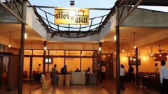 An overview of Neel Da Dhaba Restaurant with people walking around inside - VITS Select, Rajkot.