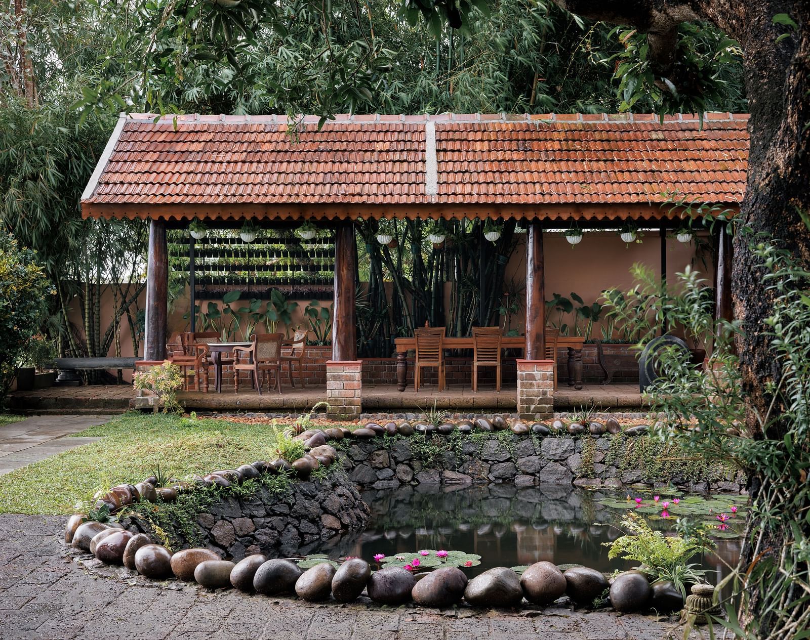 A facade image showcasing the pond at BluSalzz Villas - Muhamma Resort, Alleppey and the outdoor seating area of the restaurant