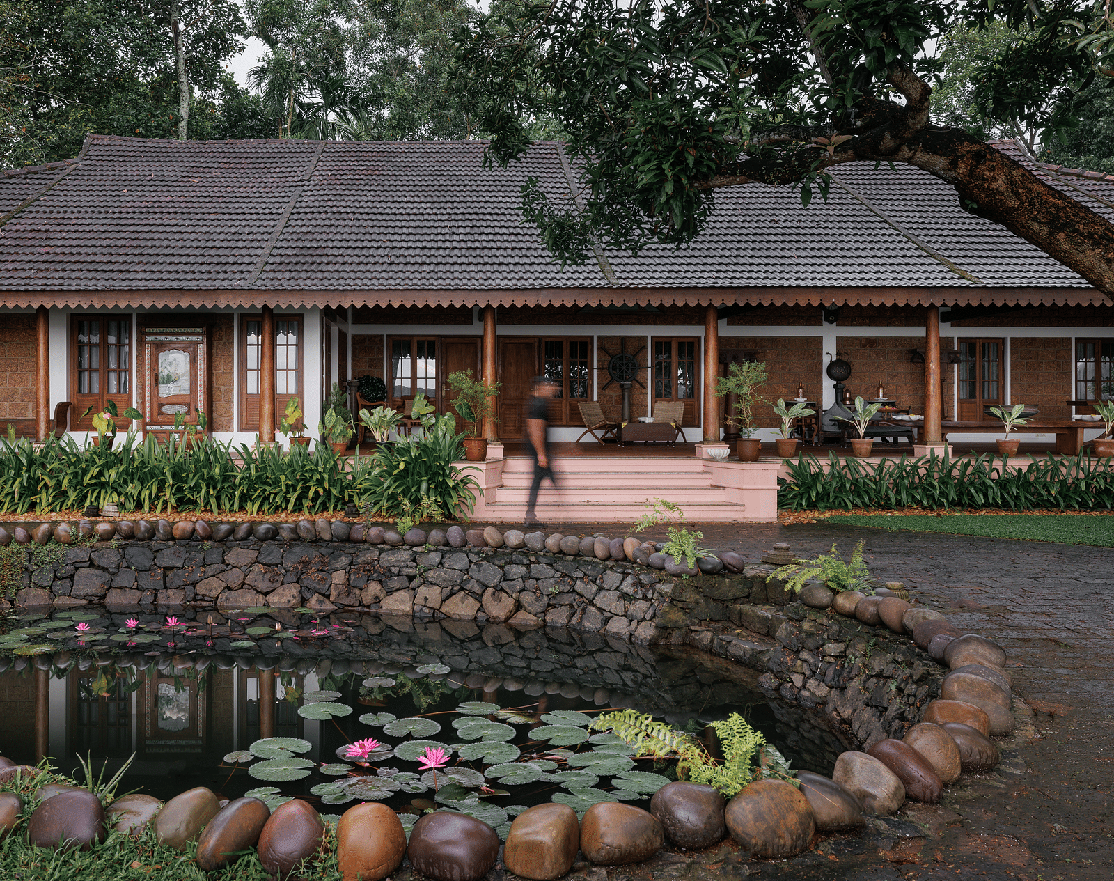 A facade image of BluSalzz Villas - Muhamma Resort, Alleppey with a pond in front of the resort