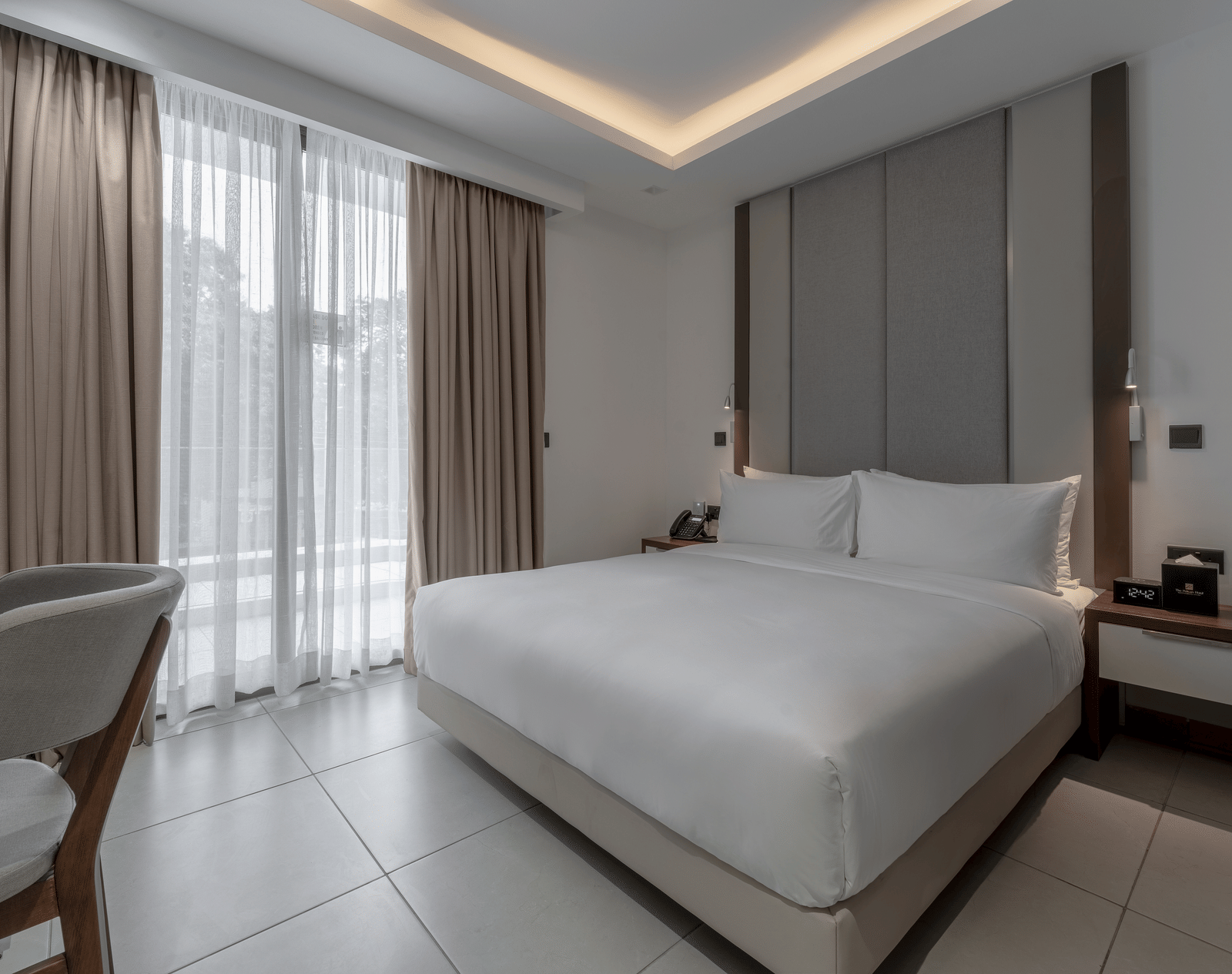 Luxurious Premier Suite offers a king bed, modern decor, and elegant furnishings for a relaxing stay. - The Pelican Hotel, Accra