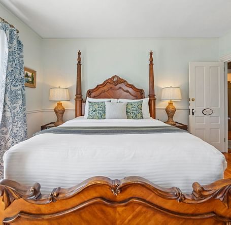 Room with ornate four-poster bed and classic decor at Hartstone Inn.