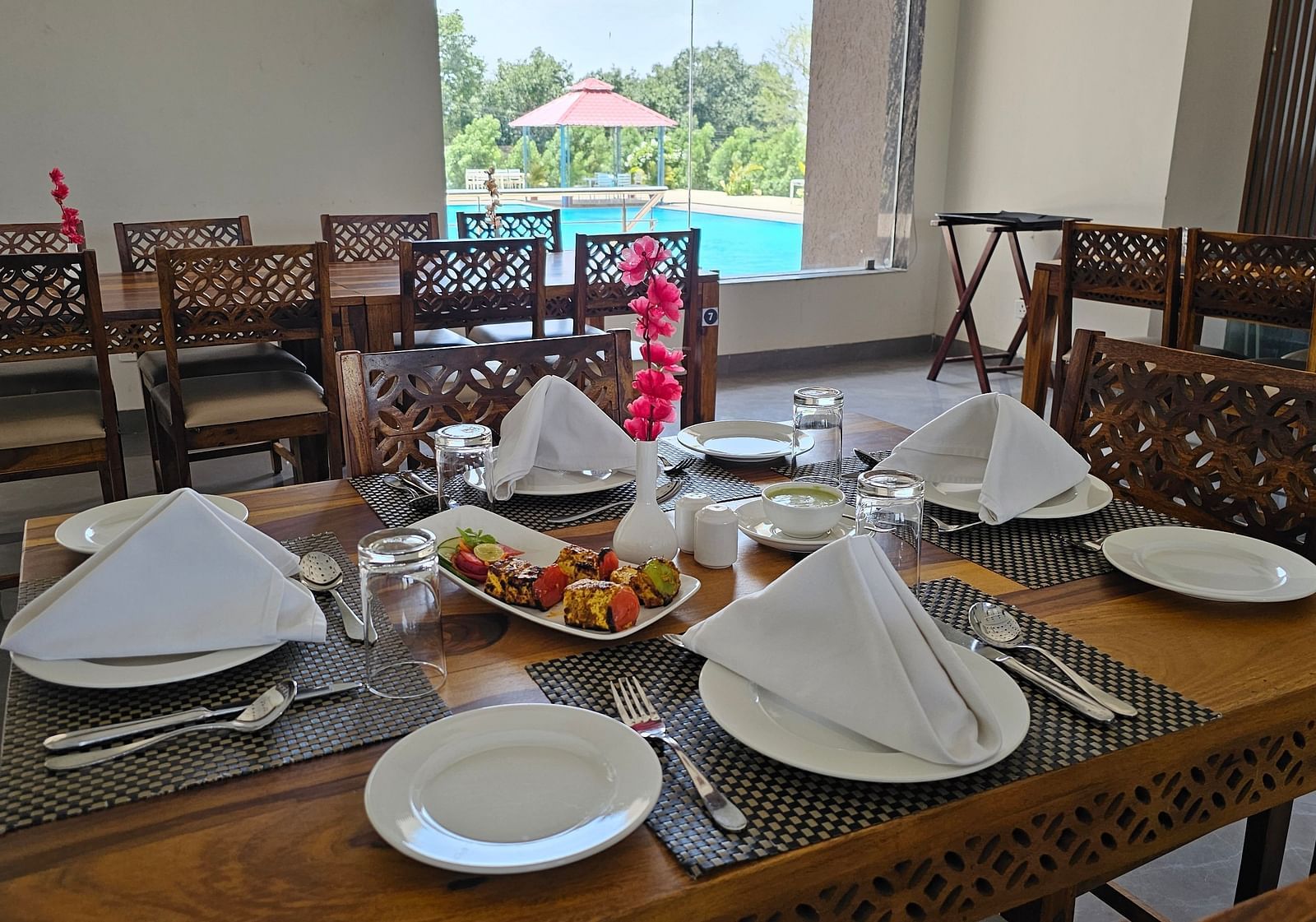 A dining table is laden with various food items and cutlery - Bamboo Saa Mulberry Resort, Pushkar