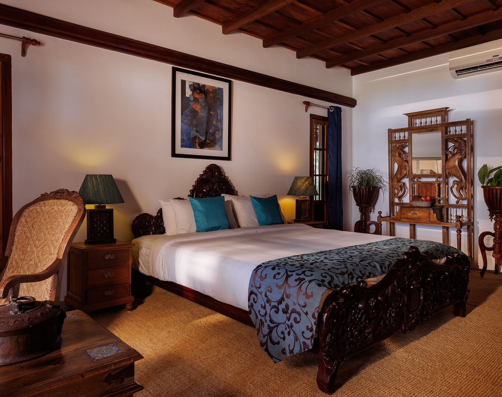 A room with a bed, a wooden dresser, a chair, and a coffee table - BluSalzz Villas - Muhamma Resort, Alleppey
