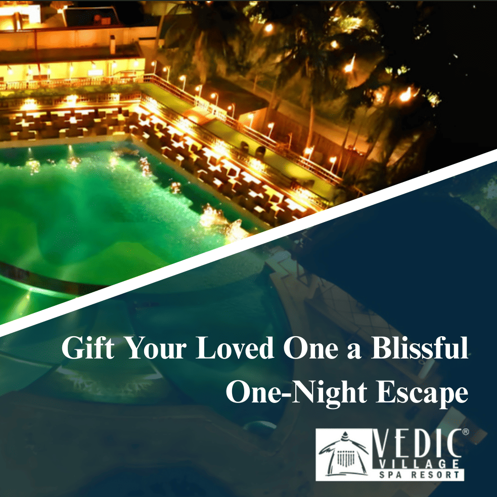 Aerial night view of Vedic Village Spa Resort’s glowing pool, surrounded by greenery and lit pathways, promoting a one-night escape gift.