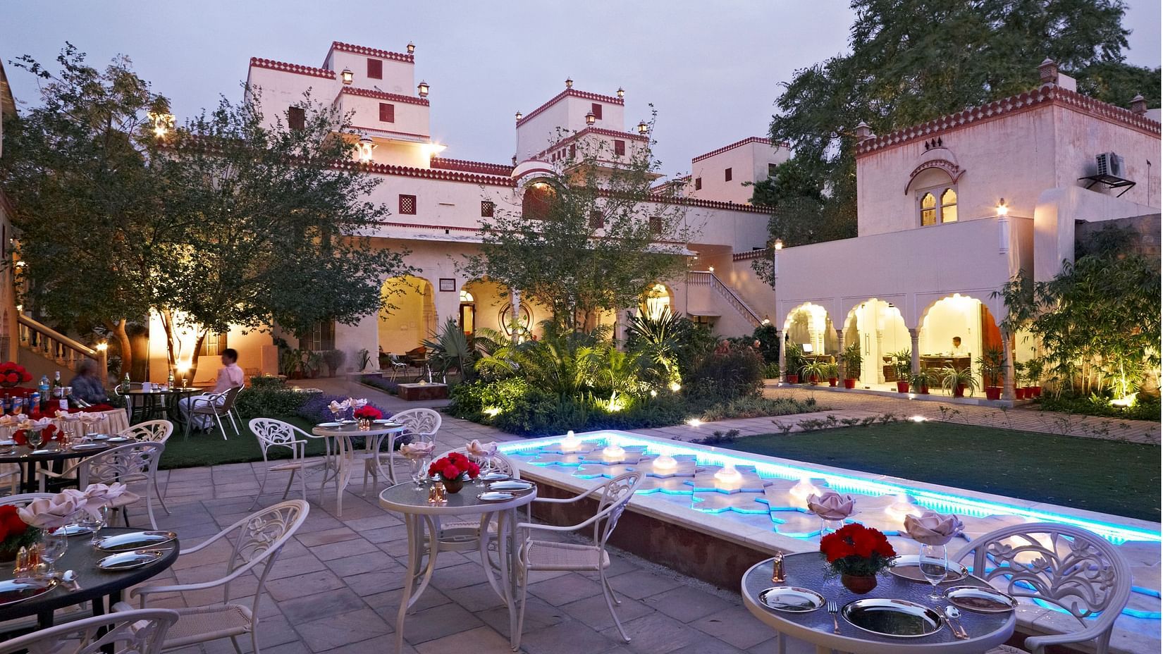 Seating arrangements next to a fountain in the evening - Mandawa Haveli, Jaipur