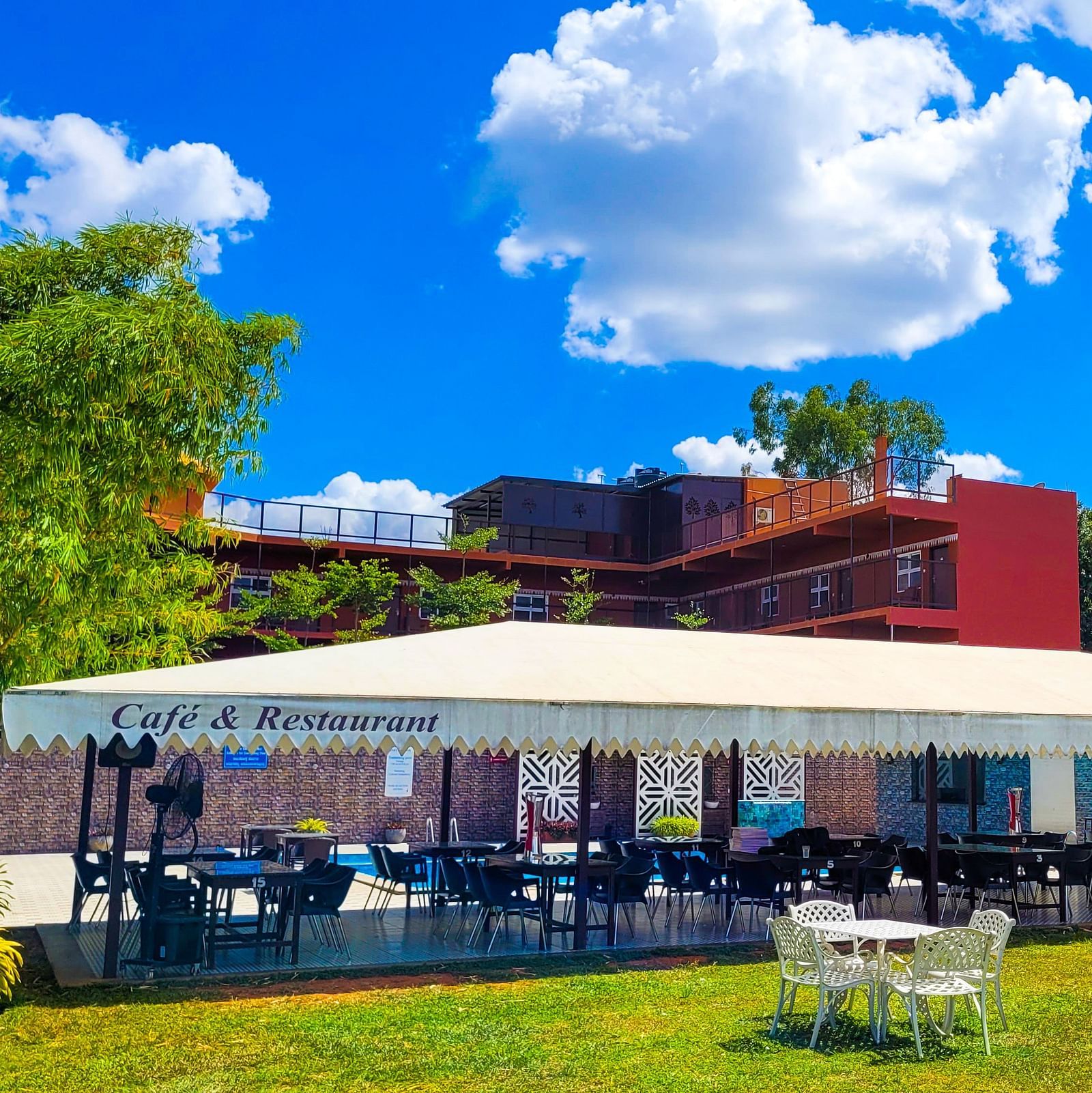 Wide view of a covered restaurant during the day | Vistar Resort, Bengaluru