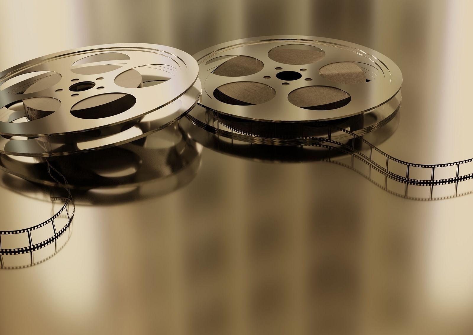 A close up shot of two movie reels next to each other placed on a table.