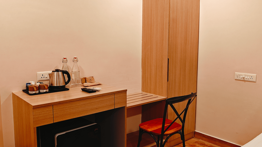 A section of the bedroom at Barren Villa showcasing a tea and coffee setup with a small desk and chair