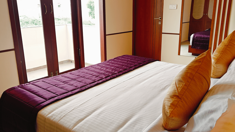 A double bed positioned beside a window in a room at Bliss Giriya By Bergamont Tiruvannamalai.