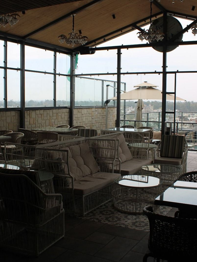 Rooftop lounge space with seating arrangements at BluSalzz Residence, Amritsar.