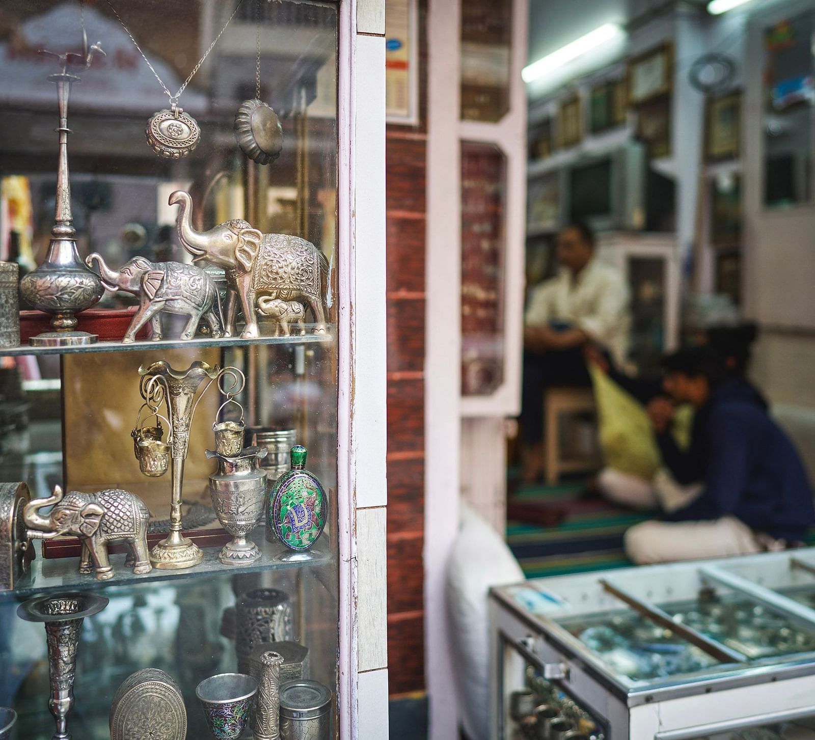 image of shop that features traditional rajasthani antiquities and jewellery on the outside display protected with a glass partition 