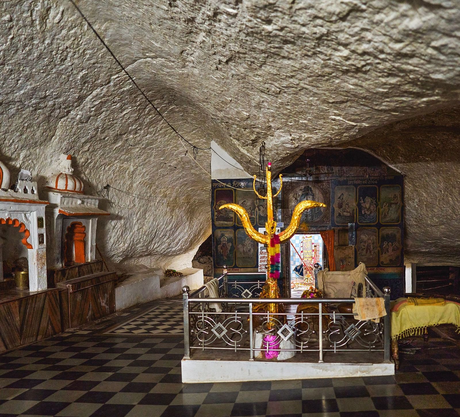 image of a temple site featuring a trishool in the middle