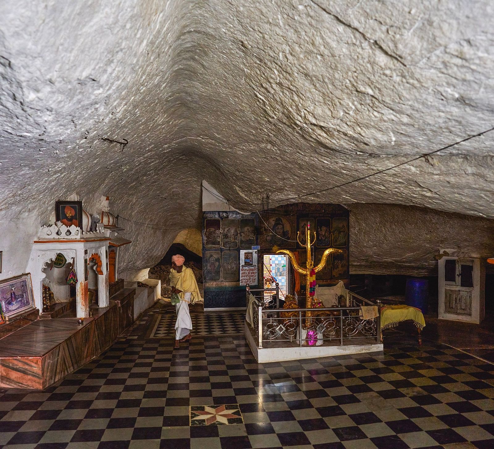 image of a pilgrim site constructed inside a cave with white coloured ceiling at the top