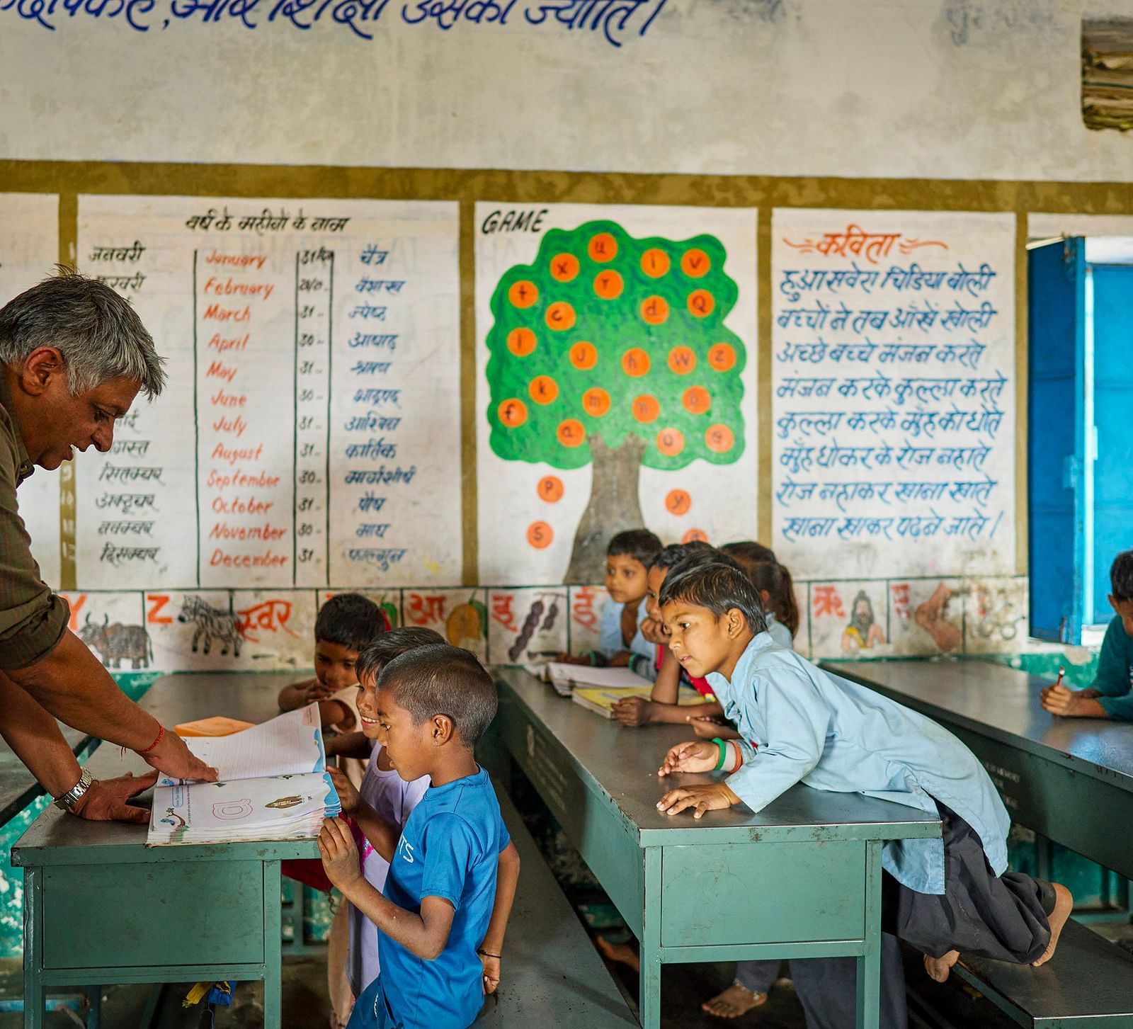 image of an old man teaching children in a government school 