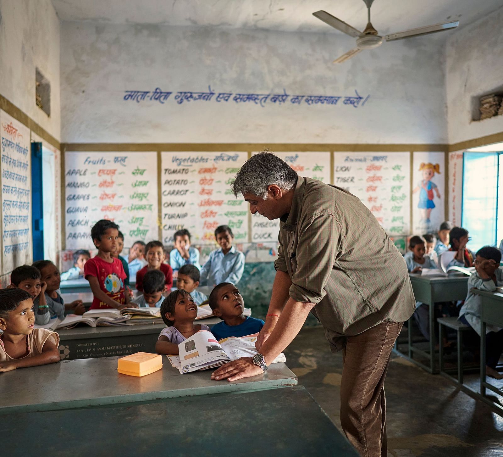 image of an old man attending to students personally at a government schhol