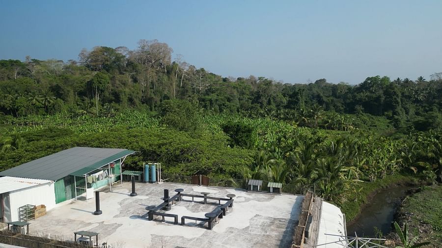 An aerial shot of Matsya Island Retreat showing a complex of buildings, a swimming pool, and extensive green landscape.