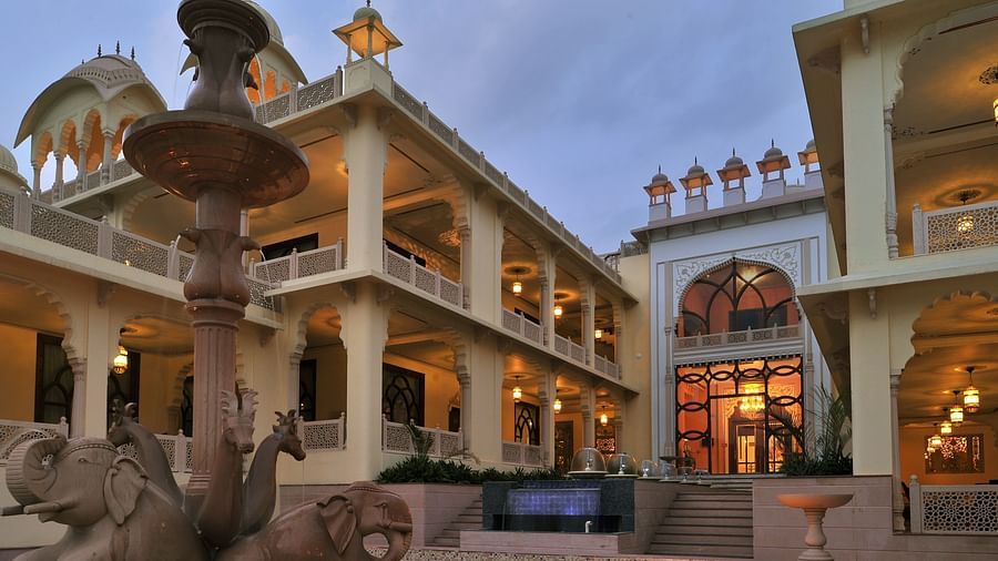 Facade of Rajasthali Resort & Spa Jaipur with lights glowing from the inside.