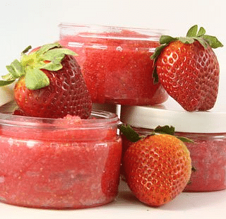 An image featuring a blank background with three filled small transparent containers, and three strawberries placed around them.
