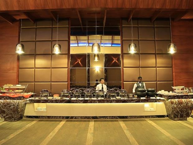 A live buffet station with chefs in action, offering a wide selection of gourmet dishes in an elegant setting. - Dhanalakshmi Srinivasan Hotels, Perambalur