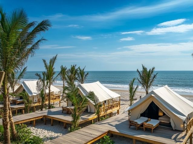Sub-aerial view of tents on wooden paddocks on a beach