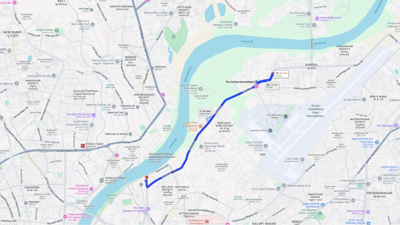 A close-up of a street map showing an area with a prominent river running through it and a line indicating a route to Sardar Vallabhbhai Patel National Memorial from The Ummed Ahemdabad.