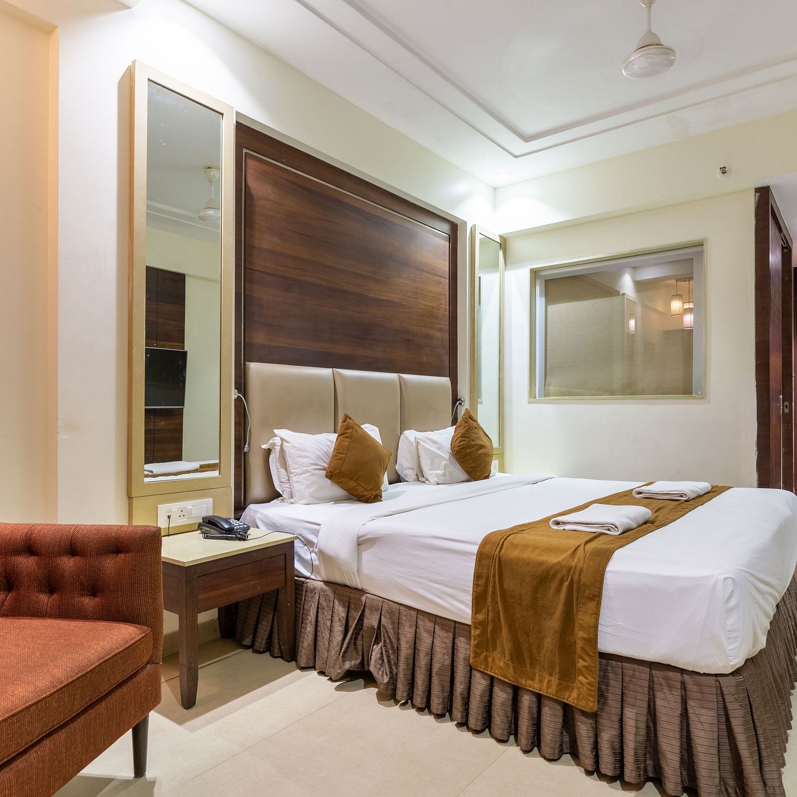 Image of a room with a bed and a sofa on the side at Calux Grand Inn, Calangute.