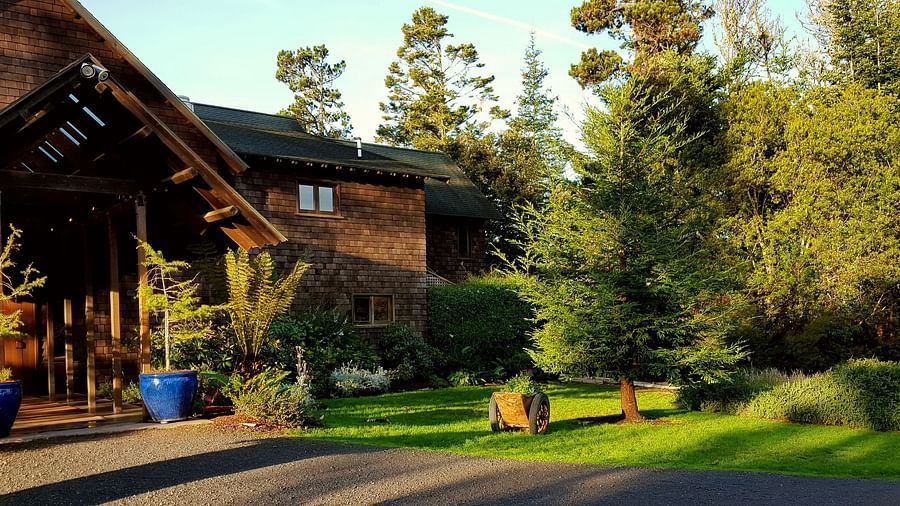 The entrance to our charming Inn surrounded by lush garden and golden sunlight - Brewery Gulch Inn & Spa