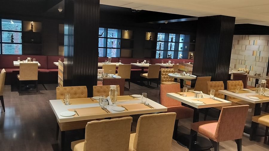 Contemporary restaurant with arranged dining tables and upholstered chairs in a well-lit space