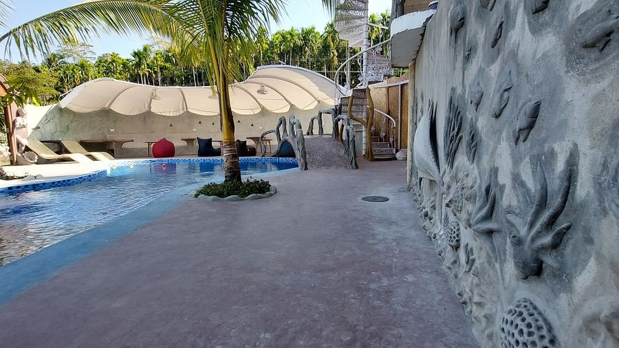Verdant paradise with a sparkling pool nestled amidst swaying palms-Matsya Island Retreat by Island Quest.