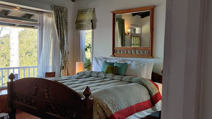 Premium Room with bed and a large window with a mirror above the bed at Te Aroha by Shervani Mukteshwar
