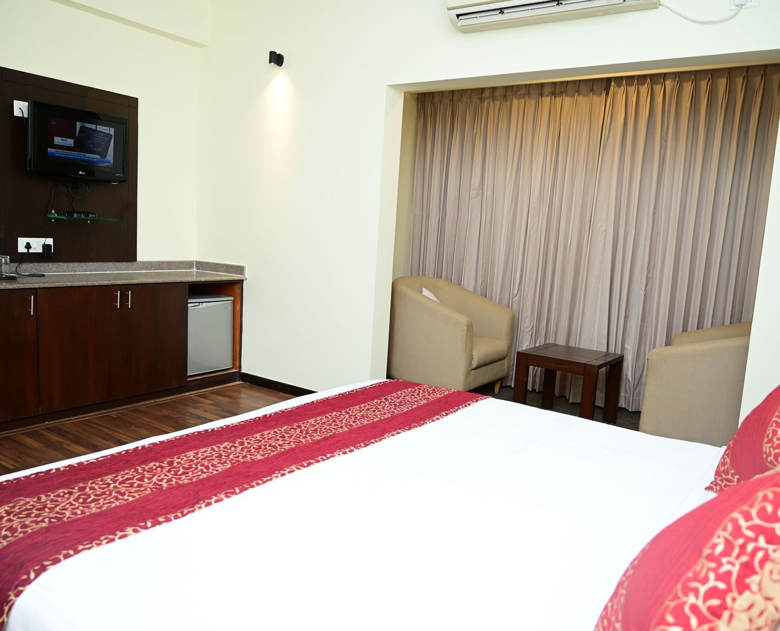 Side view of a double bed and a small cabinet in the Executive Suite at Sterling Keys by TGI