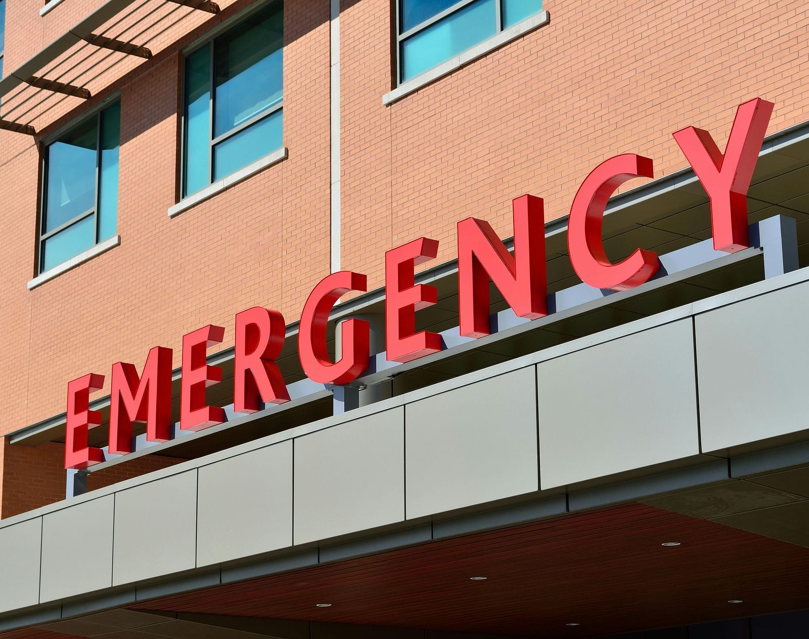 The word 'EMERGENCY' on the exterior of a building.