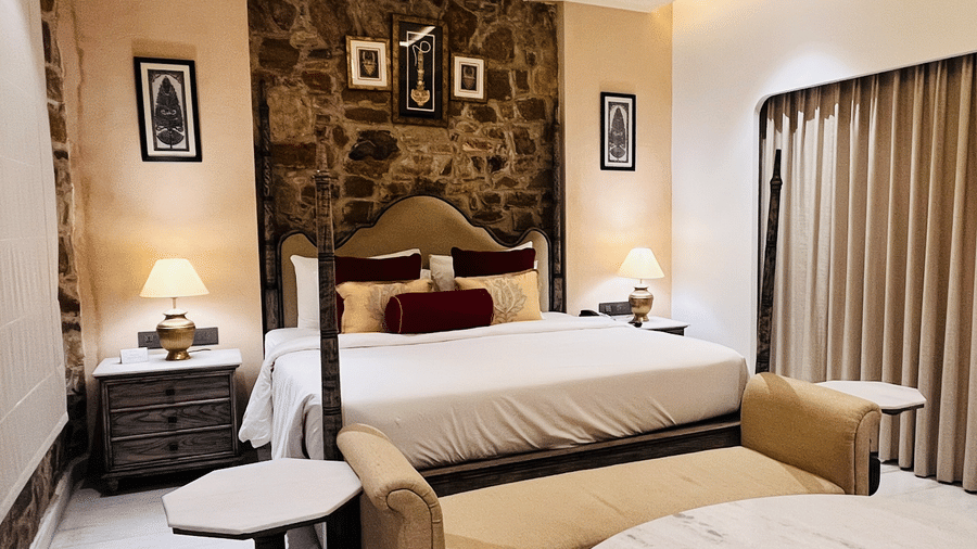 Premium Deluxe Room living area at Juna Mahal, Ranthambore with elegant seating, marble flooring, décor accents and spacious ambiance