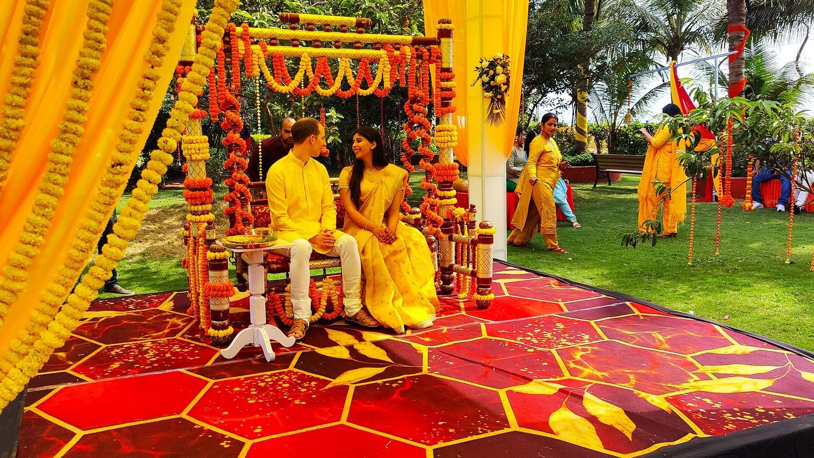 Swosti Chilika Resort - Image of a couple in traditional Indian attire seated on a decorated piece of furniture uvsldp