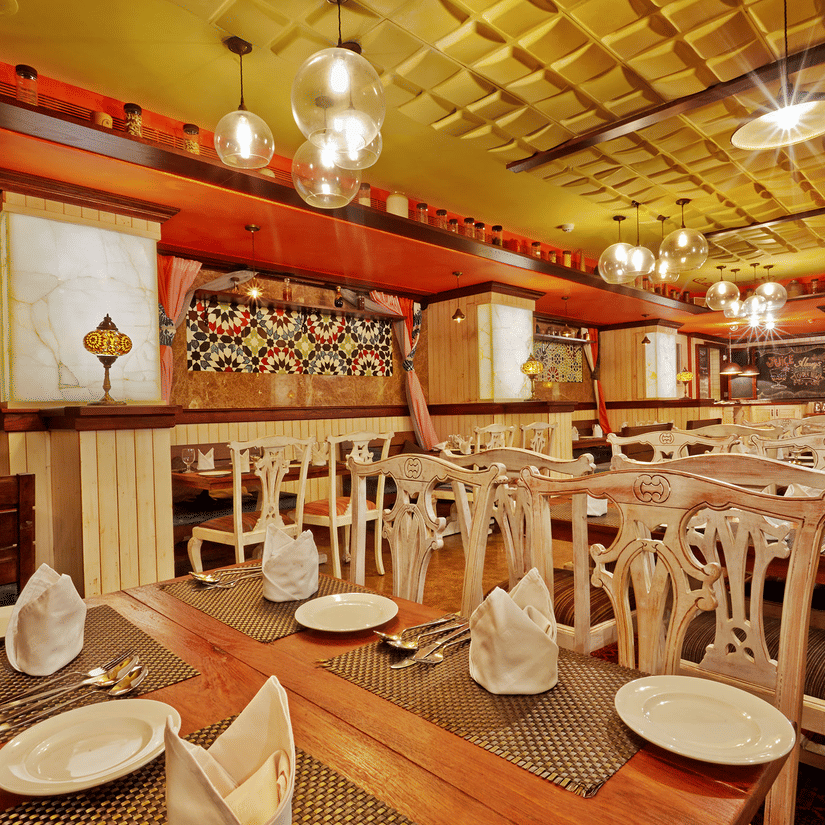 Dining tables with chairs at The Spice, a popular buffet restaurant in Chennai, located at Hablis Hotel.