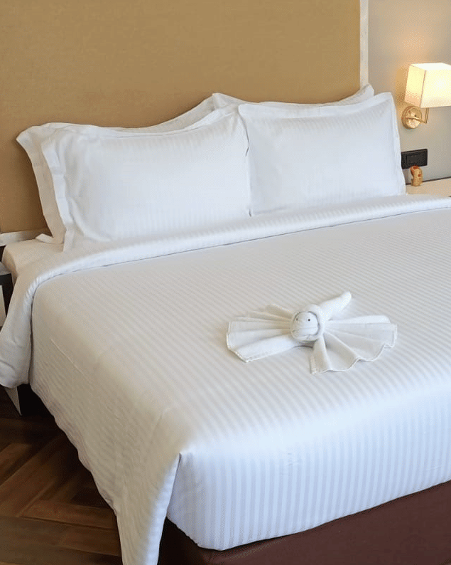 guestroom-king-bed-orange-armchair