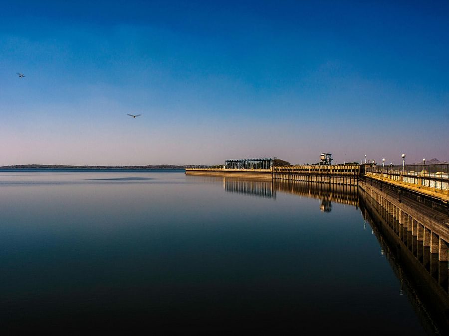 A scenic view of the Krishna Raja Sagara reservoir at sunset.