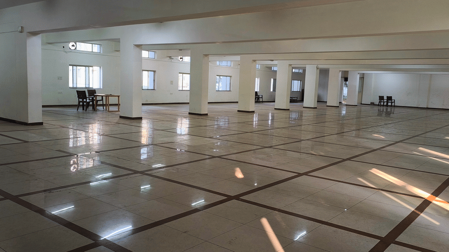 A large, empty banquet hall at BNGV Grandeur Hotel and Banquets with a distinct tiled floor, ready for various events.