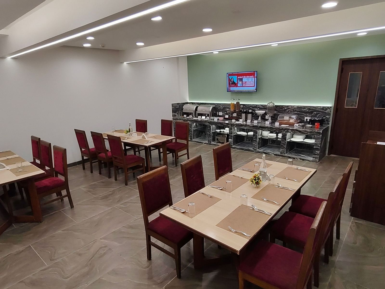 Restaurant-style dining area with red chairs and wooden tables