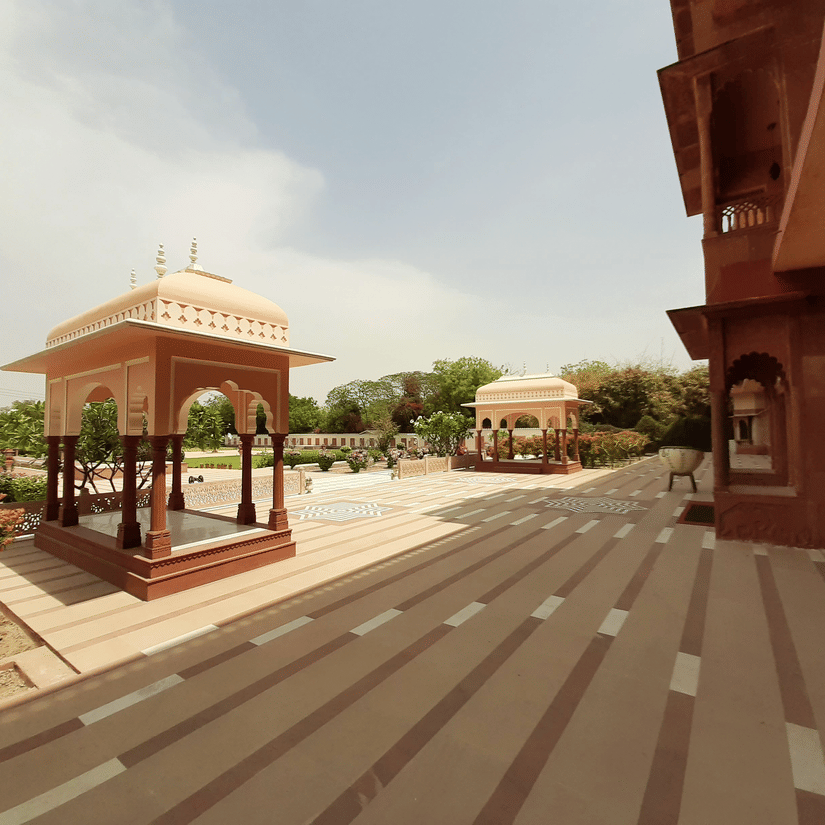Heritage courtyard and pavilion architecture at Umaid Palace with landscaped gardens.