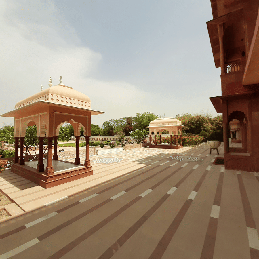 Heritage courtyard and pavilion architecture at Umaid Palace with landscaped gardens.