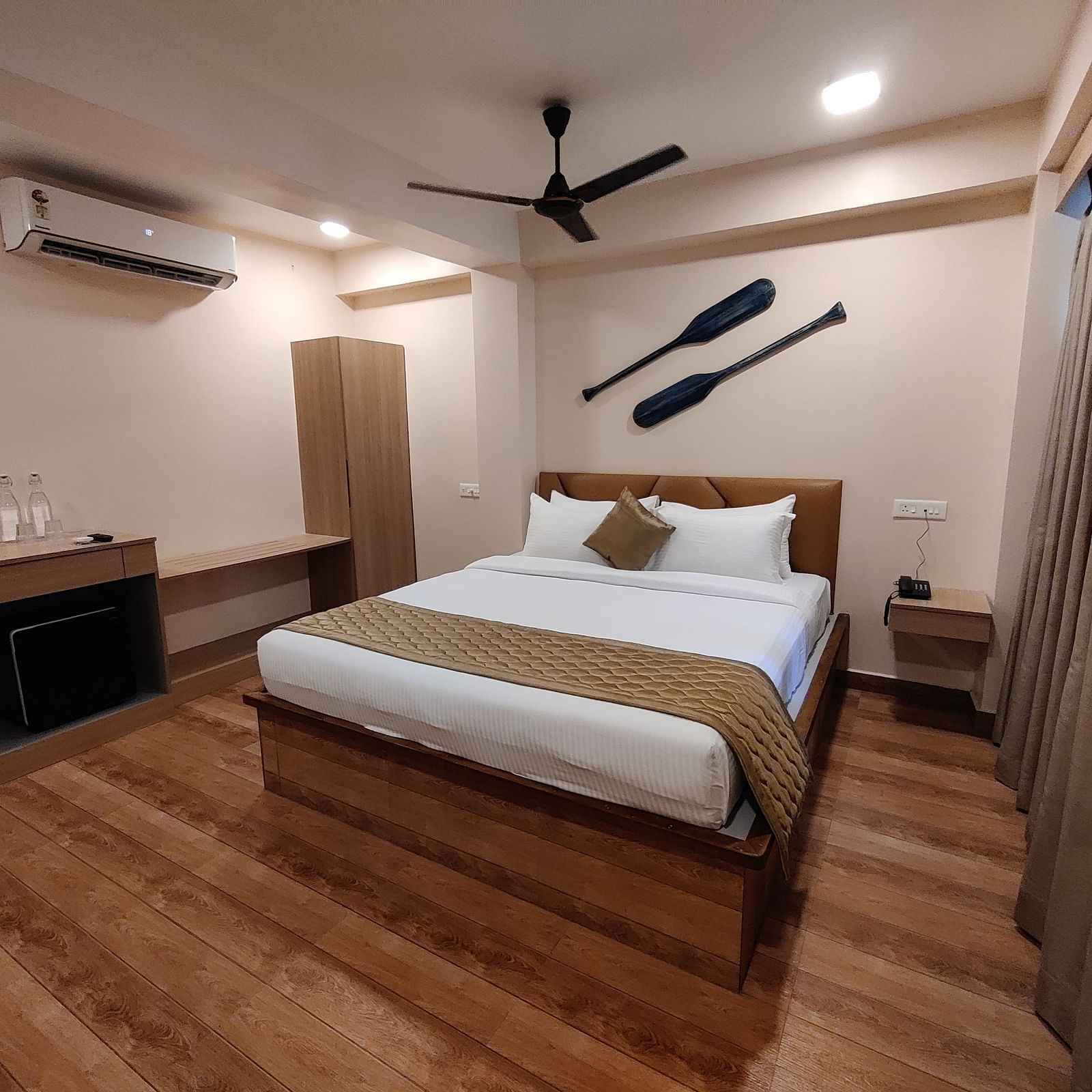 Elegant room with wooden flooring, cosy lighting, and minimal décor - Arina Island Resort, Swaraj Dweep