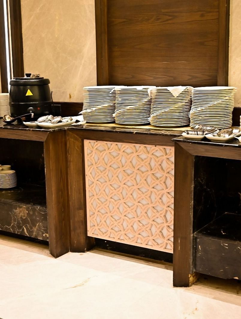 Cutlery elegantly arranged on a rustic wooden table at BluSalzz Residence, Amritsar