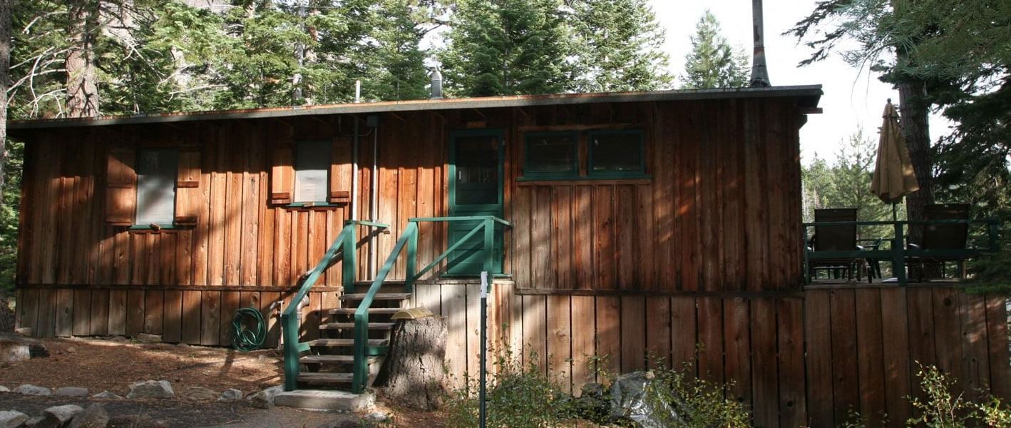 A rustic wooden cabin exterior at Kit Carson Lodge.