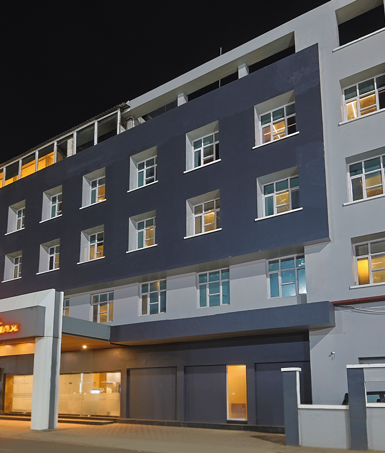 Night view of Max Hotel Prayagraj exterior with lit entrance.
